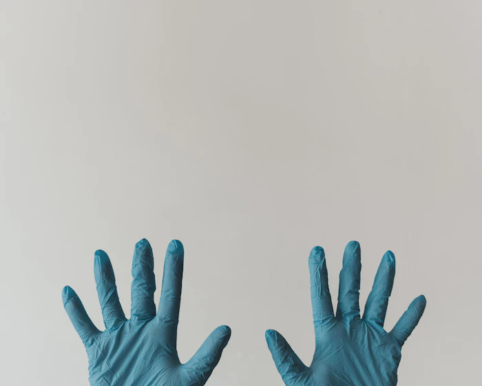 Two hands in fresh nitrile gloves